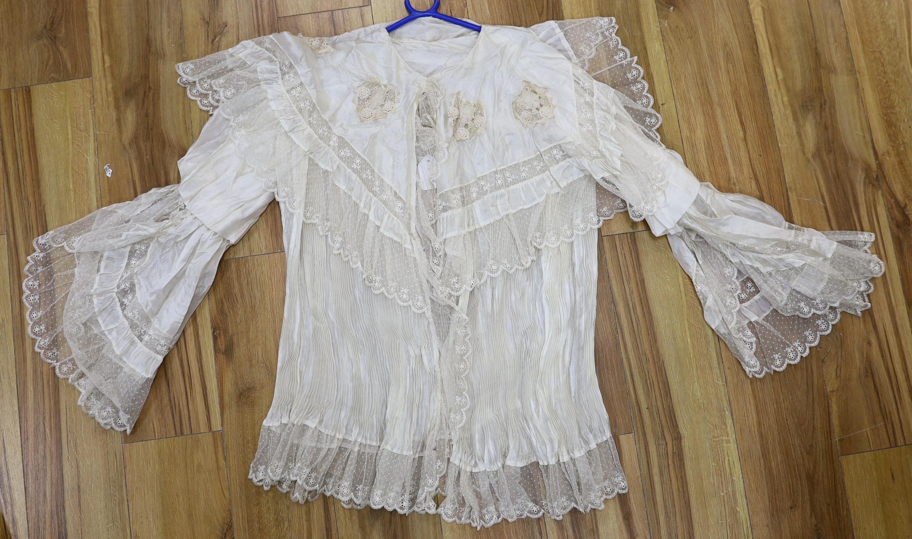 A fine cream silk and lace inserted pleated jacket